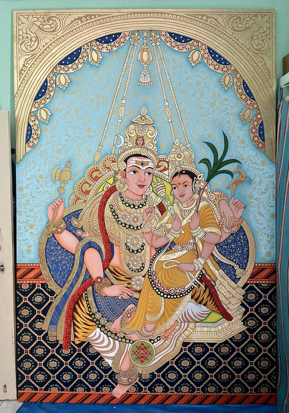Traditional figurative devotional painting in gold and blue