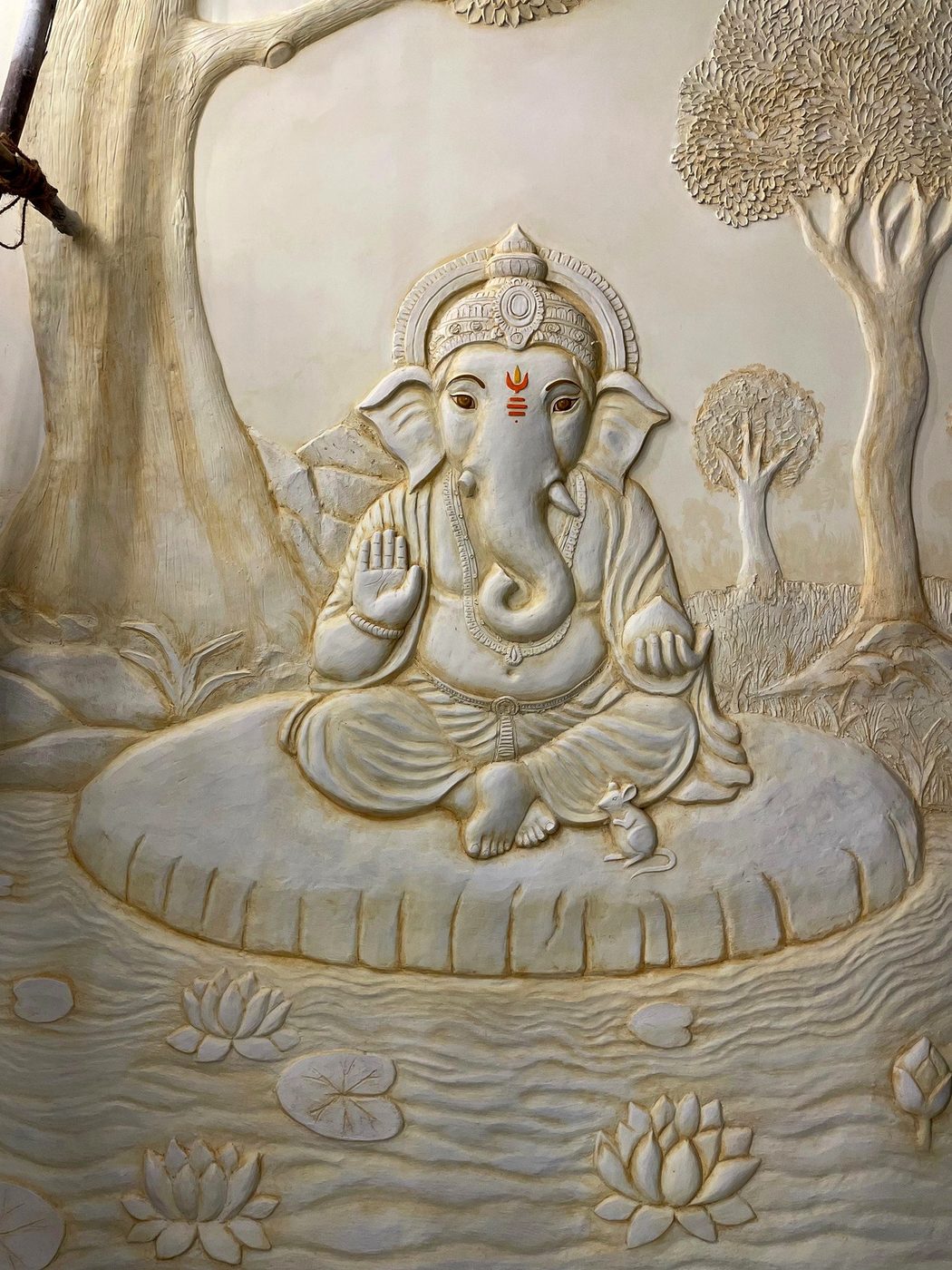 Sculpted Ganesha relief with lotus and tree