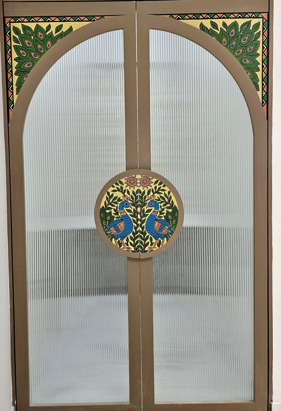 Hand-painted peacock medallion on a fluted portal