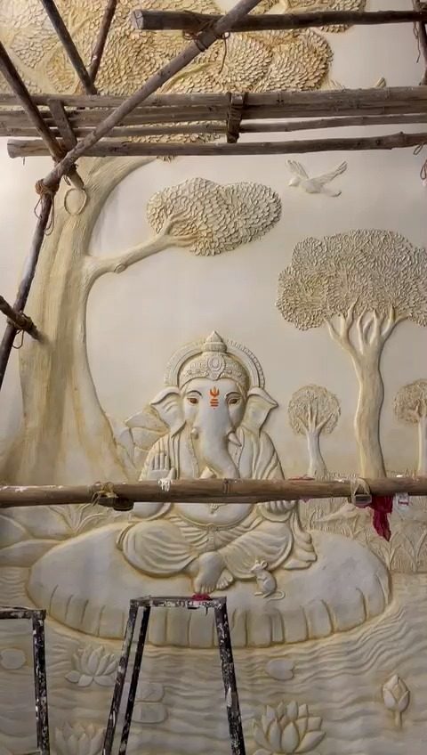 A Ganesha relief being sculpted on site from scaffolding