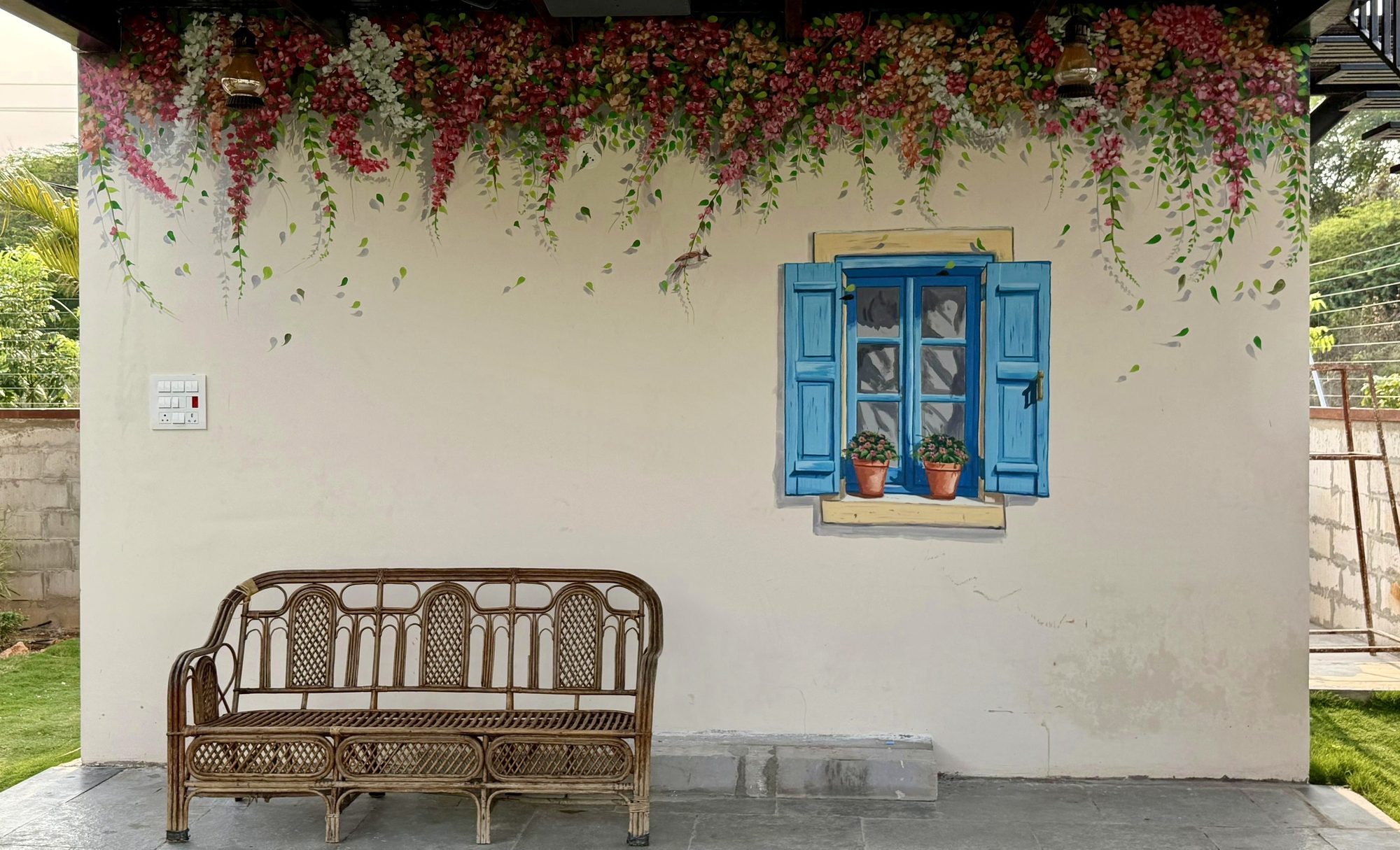 Trompe l'oeil window with bougainvillea on an exterior wall